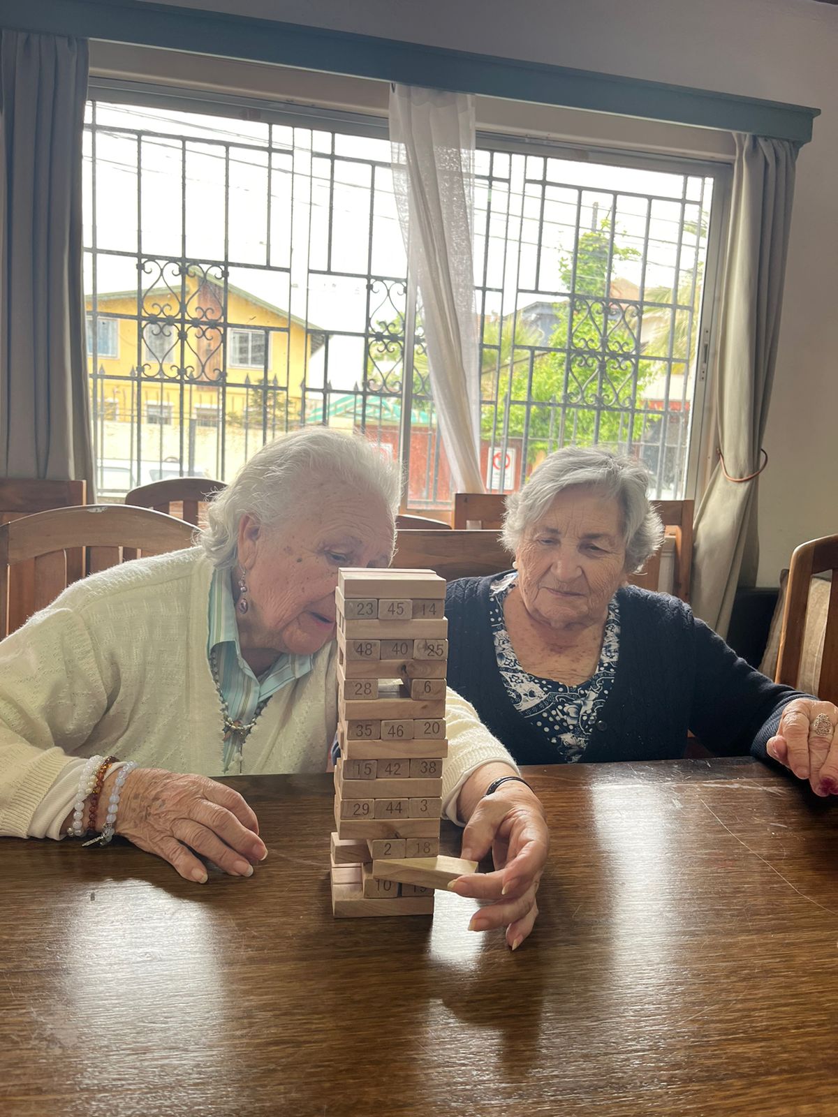 Residentes jugando Jenga en el taller de motricidad